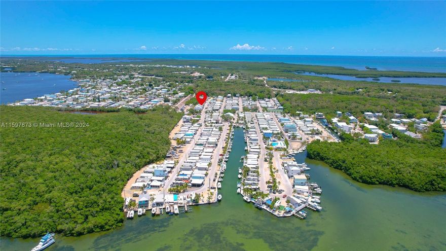 BEST BUY OF ALL in boater's paradise, fabulous Calusa Campground, Key Largo, FL. Truly turnkey & ready for good times. Have someone else pay for your Florida Keys vacations! Use as full time residency, part time use w/ great income potential (rental program/AirB&B/Vrbo/daily rentals) or build permanent for higher returns (ROGO exempt) this beauty has it all! Semi private lot, fully furnished, huge (39 ft) Salem RV by Forest River w/ over 400 sf of living space. Supersized A/C (2 mini splits) 408 sf covered concrete patio, insulated aluminum roof/ventilation, 36 foot carport w/ canvas & 25-28' boat storage, storage shed, 2004 Club car golf cart, 4 TVs, 2 refrigerators & BBQ included! Common ramp/dock, heated pool, tennis, sunset deck, pickle/basketball, playground, clubhouse & 24h security.