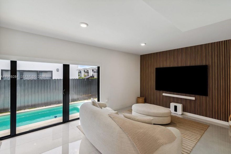 This modern new construction features 5 bedrooms, 3 remodeled bathrooms, impact windows, porcelain tile throughout, and a smart home system. Includes a 19' x 7' in-ground pool, pergola will Not convey, aluminum gates, and 5-camera security system. Bedrooms come with blackouts and blinds, plus modern drain gutters and custom upgrades throughout. Prime location near Fresh Market, Zoo Miami, and just 30 minutes from the Florida Keys. Stylish, secure, and move-in ready! The open-concept design is perfect for entertaining, with seamless indoor-outdoor flow. Spacious layout offers comfort and privacy for families or guests. Ideal for those seeking luxury living in a growing area.