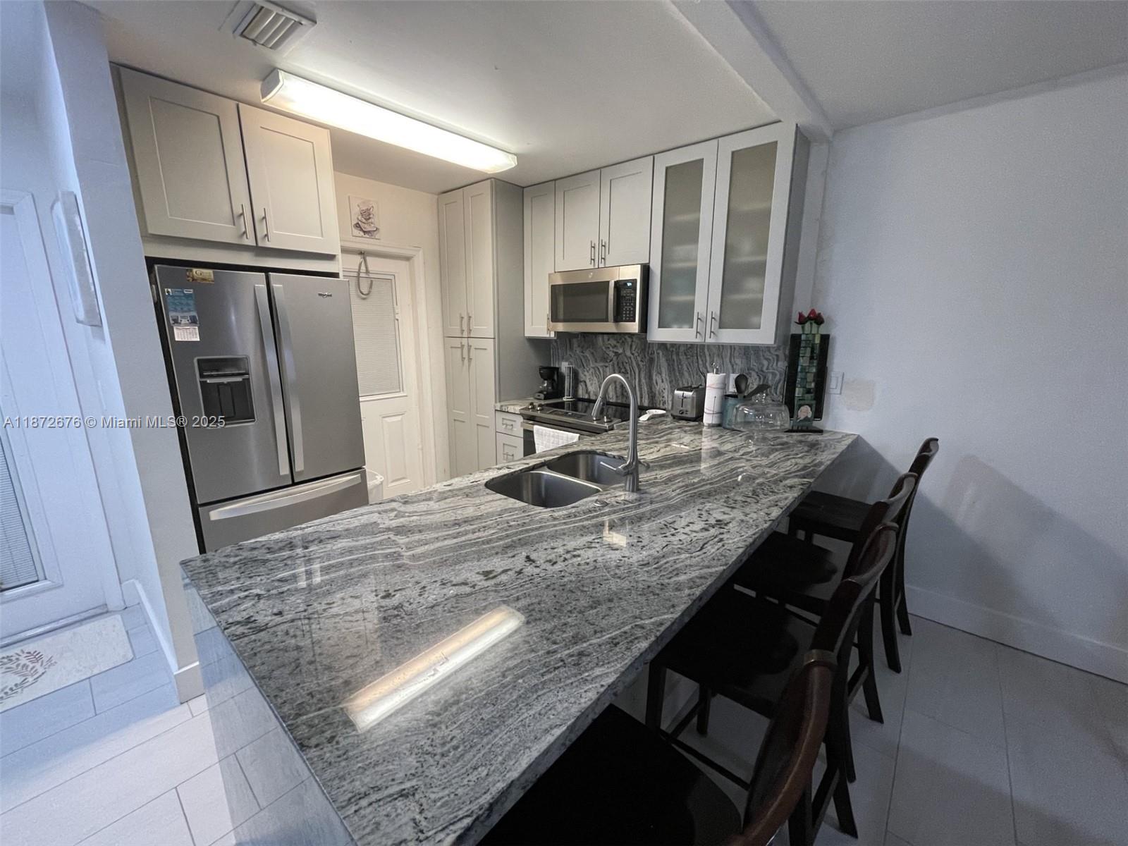Enjoy living in this condo for the Season!. This 2/2 condo located on the first floor comes completely furnished and equipped with all you need. Renovated open kitchen with granite counters & great pantry and high impact windows. Hawaiian Gardens community offers you great living and activities while loving the Florida weather. Designed for a perfect vacation retreat offering a peaceful lake view, well-maintained community with lush landscaping, a sparkling pool, gym, shuffleboard, BBQ area and a relaxed vibe. Located in the heart of Fort Lauderdale, minutes from Las Olas Boulevard, Fort Lauderdale Beach, The Galleria Mall, top-rated restaurants, groceries & more. Includes water, electricity, internet. 1 Parking space on front of your door. Per association 55+, no pets, 6 months maximum.