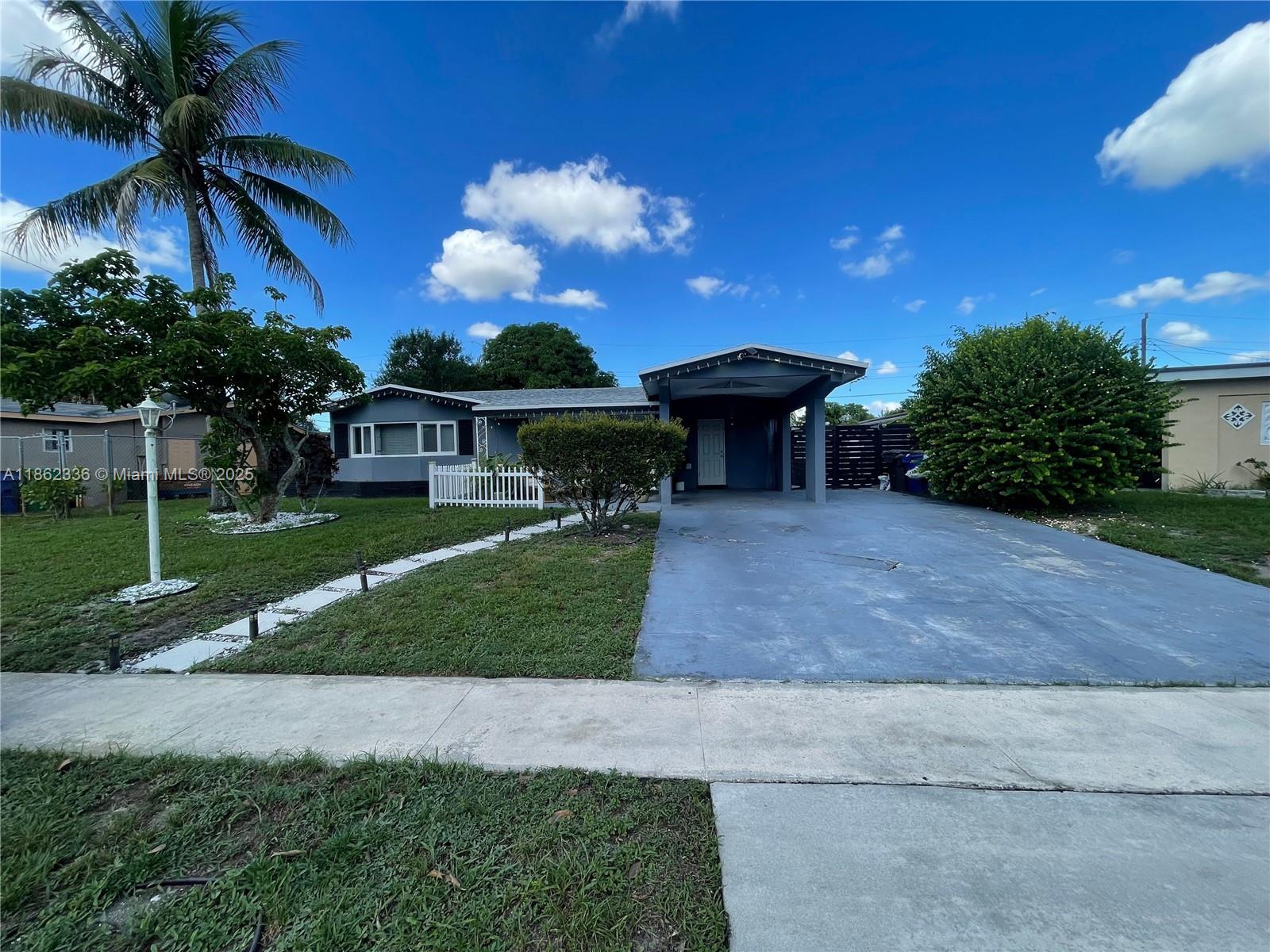 MOVE IN READY*** This elegant single-family is on a tree-lined street in the desirable greater Fort Lauderdale area, minutes to beaches, Airports, Downtown FT and Sawgrass Mills mall. Oversized 4car driveway and a carport. The front yard includes an organic coconut-producing palm tree. Soffits with dimmable led lighting. 2023 Full roof replacement with 10yr wrnty. Dec 2022 new AC with 10yr wrnty. Entrance- you have durable waterproof vinyl wood flooring continuous throughout, fresh paint, and a bright and open floor plan. Kitchen: Quartz countertops & backsplash with cabinets to compliment flooring and brand-name appliances. The backyard- mature fruit tree casts shade over back yard, perfect for sunny S. Florida summer. Paved portion of the yard allows space for a great BBQ grill.