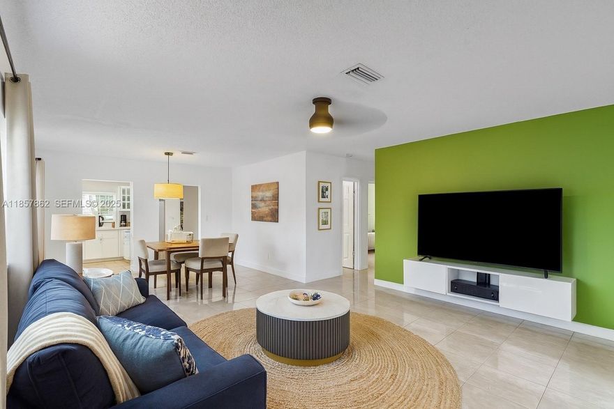 Minutes from Downtown and the beaches, this well-maintained home offers 1,890 sq. ft. of bright, open living space. The inviting floor plan flows from a spacious living area to an updated kitchen with modern appliances and plenty of storage. The main home features 2 bedrooms and 1 bathroom, plus an extra full bath for added convenience. A separate in-law suite with a private entrance, bedroom, and bath provides versatility for guests or extended family. Enjoy peace of mind with a newer tile roof, newer AC system, and full impact windows throughout!