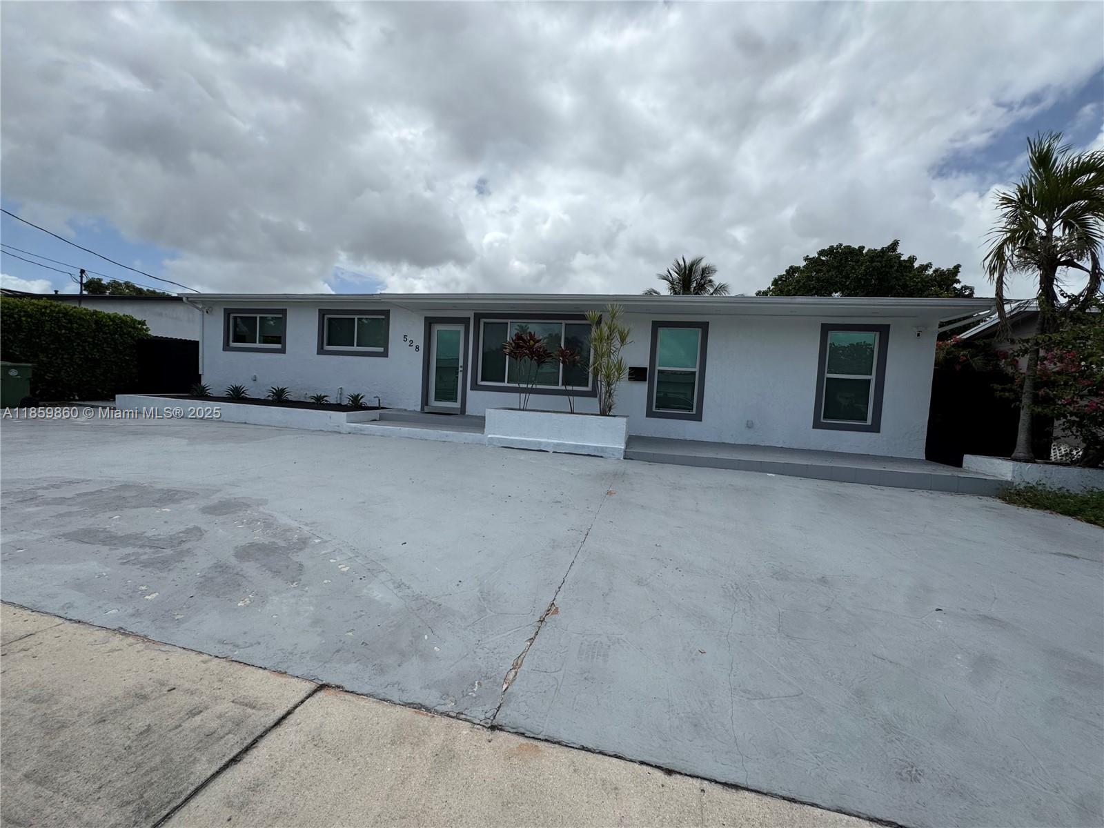 Spacious 8-bedroom, 4-bath home featuring a 2019 roof, new impact windows, new A/C, and new water heater for peace of mind. Designed with versatility in mind, the property offers separate living areas—ideal for twin families seeking privacy while sharing one home. A new fence surrounds the large backyard with a canal view, providing extra seclusion and space for a future pool. The circular driveway adds convenience and curb appeal. Perfect for multi-generational living or those needing abundant space in a serene setting!