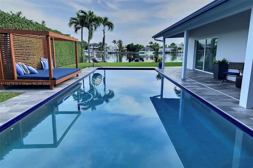 Lowest-priced waterfront home over ¼ acre lot in all Miami Beach/Surfside/NBV/Bal Harbour! Recent price drop for quick sale. Motivated seller! This fully remodeled home totaling 2721sqft boasts 72ft of prime waterfront on wide water with no fixed bridges. Enjoy the sun from your new 30ft dock (completion Feb) with two boat slips including one for up to a 60ft boat, or the resort-style pool deck complete with custom cabana. 4 bed/3 bath and bonus storage/maid's room. Updated kitchen has quartzite counters, walk-in pantry, and chef's appliances. This home is reinforced with impact windows/doors, newer roof to the latest codes, raised seawall, and solar panels. Located on gated Normandy Shores island within walking distance to beach, parks, tennis, and golf club.
