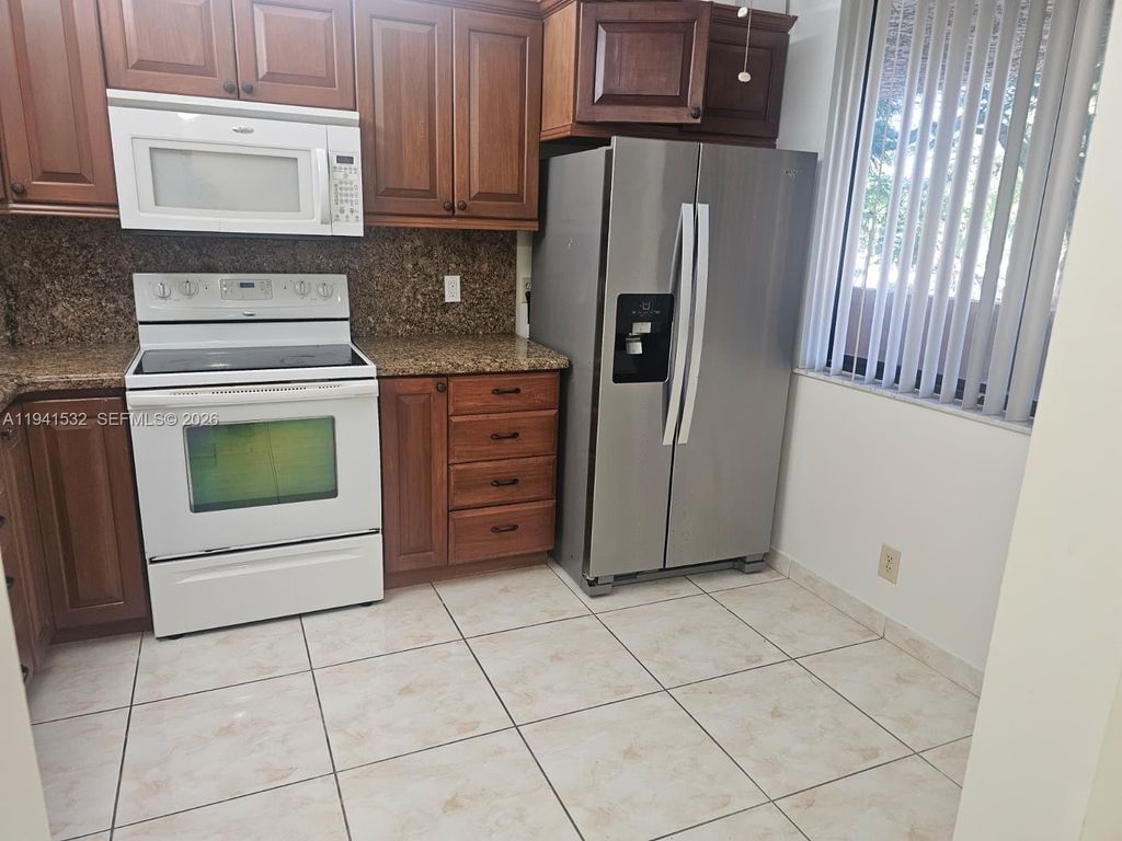 Photo of 8592 W Sunrise Blvd #209, Plantation, FL 33322 (MLS # A11941532)