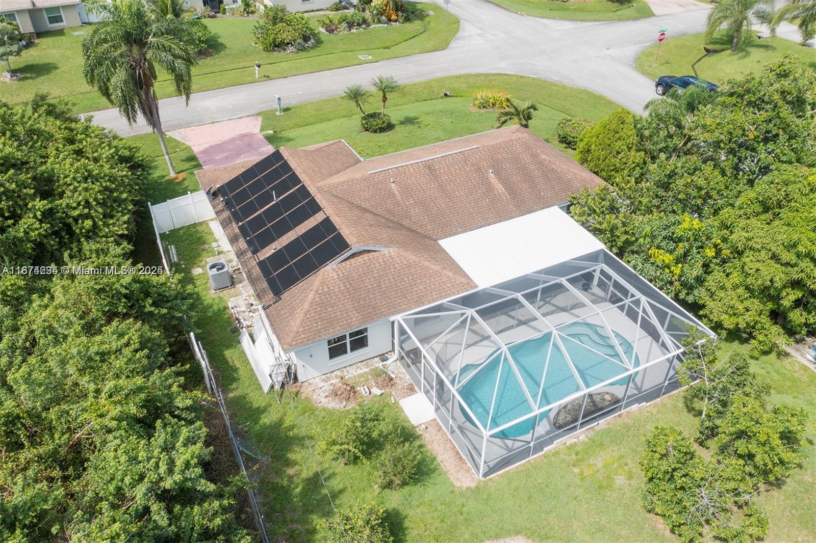 If you're looking for space, this home delivers! Step inside and discover a truly ample and open living area with a desirable split-floor plan, perfect for privacy and flexible living. Two bedrooms are located on one side of the home, while the other two are on the opposite side. Head outside to your own private oasis. The home boasts a beautiful screened-in pool with a covered terrace, creating the ideal spot for relaxing or entertaining. For added peace of mind, there's also an additional child-safety fence around the pool. Situated on a large corner lot, this home is surrounded by plush, mature landscaping that provides both beauty and privacy.