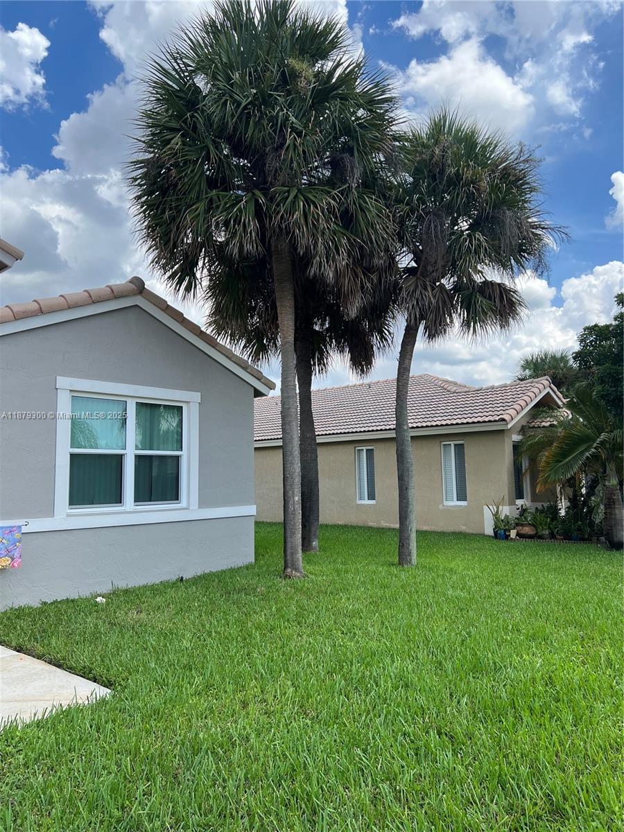 Located in the gated community of Pembroke Shores, this 4-bedroom, 2-bath home offers 2,532 sq ft of living space. The remodeled kitchen with quartz countertops overlooks the family room, while the front of the home features a combined living and dining area. The primary suite includes a renovated bath with dual sinks, soaking tub, and separate shower. A private backyard, separate laundry room, and convenient location near schools, shopping, and dining make this home move-in ready.
