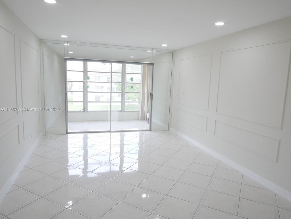 This beautifully redone apartment in Phase 3 at Sunrise Lakes has all new kitchen cabinetry, lovely quartz countertops, new SS appliances and features a large open pass through to the living room. Ceilings have all been smoothed and recessed lighting added. Main areas are tiled and bedroom has brand new carpet. Bathroom features stunning large slab format porcelain tile in shower and great new vanity with brushed gold hardware. Amazing storage with large walk in closet and additional wall closet in bedroom, another closet in hallway and built in storage in entry that holds a ton of stuff. Sunrise Lakes gives you FREE golf, tennis, theatre and much more. This Phase also includes service contract for appliances included in your low HOA fee. This great priced apartment is truly a great deal!