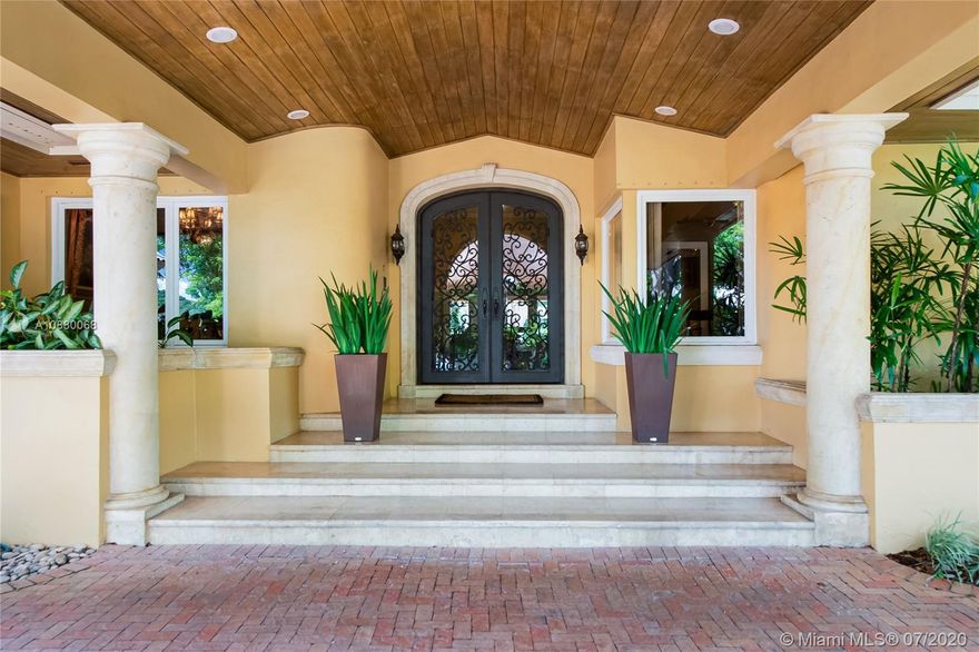 Waterfront coveted 1 story house in Cocoplum I gated community. Brick circular driveway with porte cochere. Transitional/Mediterranean style. Honed limestone and wood floors. 5 bedrooms, 5 1/2 baths and 2 car garage, with additional office and playroom. Expansive main suite and marble bath with dual sinks overlook the water. High ceilings throughout the house. Corridors are wide to display art. Security cameras. Meticulously maintained. One of the largest covered terraces in the community with Summer Kitchen and large dive in pool. Lot is .73 acres and dock is 80 feet with davits. 138 ft water frontage. Expansive wide canal water views from almost every room in the house. Only minutes to Key Biscayne by boat and close to Downtown, C. Grove and the Beaches. Enjoy the best of coastal living.