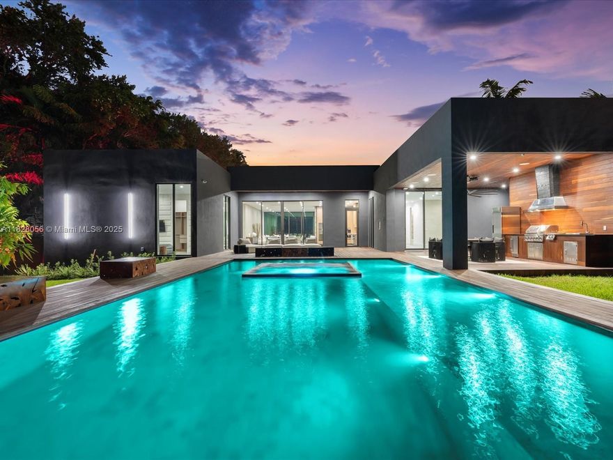 A bold fusion of architectural elegance and tropical luxury, this brand-new estate in exclusive Biscayne Heights offers a lifestyle of rare distinction. Inside, soaring 12-ft ceilings and walls of glass flood the space with natural light, highlighting refined organic finishes throughout. Featuring 5 bedrooms, 5.5 bathrooms, a private studio, and maid’s suite, the home is thoughtfully designed for elevated living. The chef’s kitchen stuns with a Wolf gas range, Sub-Zero refrigeration, wine fridge, marble countertops, and a built-in Wolf espresso machine. A full Savant system controls lighting, climate, and security. Outside, escape to a Bali-inspired oasis with a saltwater pool, Bali stone spa, Ipe wood deck, fully covered summer kitchen, and a cabana bath—perfect for elevated entertaining.