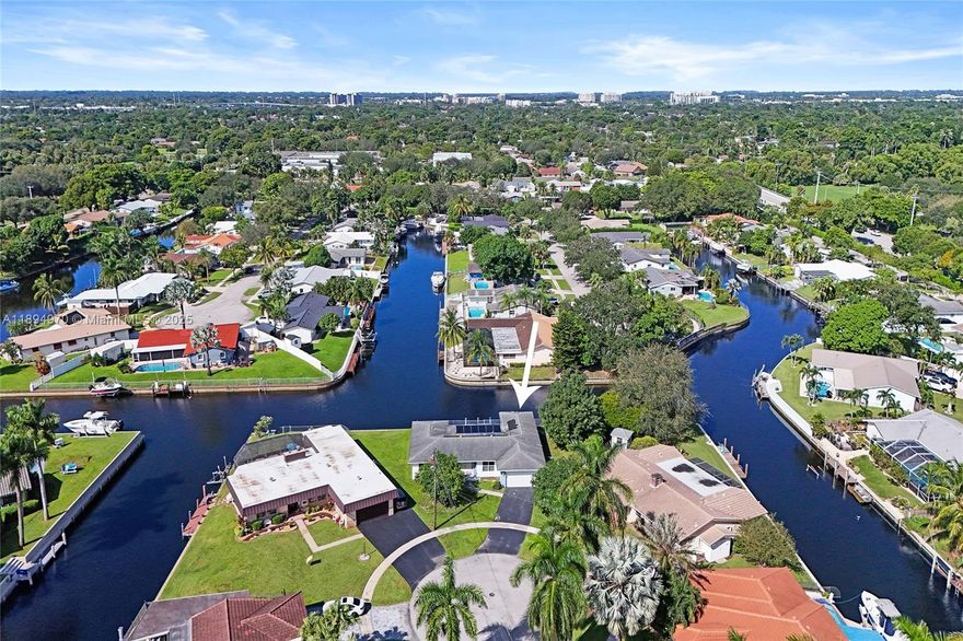 Waterfront property with ocean access — just 45 minutes to the ocean by boat from your private 160-foot dock. Set on an oversized triangular lot at the end of a quiet cul-de-sac, this home offers privacy, expansive water views, and the essence of South Florida living. Enjoy a solar-heated saltwater pool, covered patio, and open outdoor spaces ideal for relaxing or entertaining. Impact-resistant windows and doors, an electric two-car garage, and driveway parking for four provide comfort, security, and convenience. The fenced and open yards offer room for gatherings or pets, while the covered front porch is perfect for enjoying the shade or watching the moon rise. Located near parks, shopping, highways, the port, and the airport.
