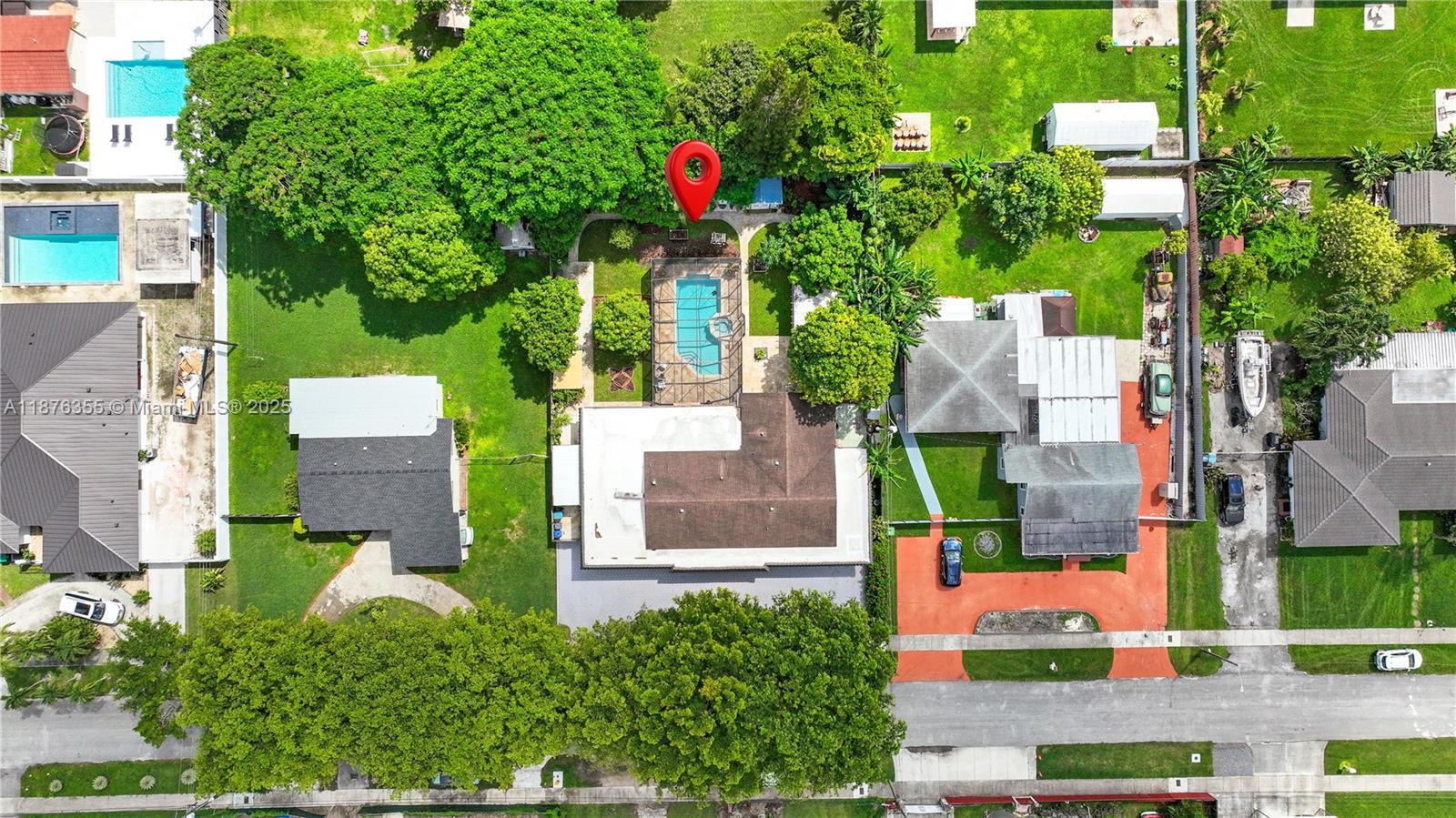 Discover a home designed for those who love the outdoors and living off the land. Set on a generous 14,500 SF lot with 3,202 SF of living space, this updated residence blends comfort with self-sufficiency. Surround yourself with lush greenery, abundant fruit trees—mango, avocado, guava, banana, jaboticaba, sapote—and dedicated flower/vegetable beds. A chicken run with coop provides fresh eggs daily, while multiple sheds offer space for gardening and storage. Outdoors, enjoy a screened pool with travertine deck, outdoor kitchen, pergola, and space for entertaining. Inside, impact windows/doors, roof (2018), updated kitchen, newer A/C, and upgraded closets. This floor plan is flexible layout and could provide space for an efficiency or in-law quarter. Plenty of parking and space for a boat.