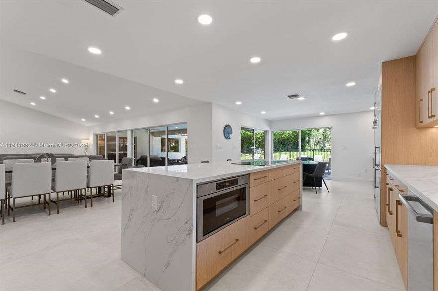 Stunningly renovated home in exclusive Delaire CC with 24-hour security and a new 27-hole golf course—no tee times required! On a corner 0.42-acre lot, this 2024-renovated home features a new roof, 4 new AC units, impact windows/doors, modern kitchen with BOSCH appliances, Sub-Zero fridge, 48x48 tiles, 5 custom bathrooms, and solid wood interior doors. Enjoy a saltwater pool, full outdoor kitchen with pizza oven, BBQ, stove, and more. Plus, a renovated 2-bedroom guesthouse with private entry. Community offers fitness, tennis, sauna, playground, and social events. Book your private showing today