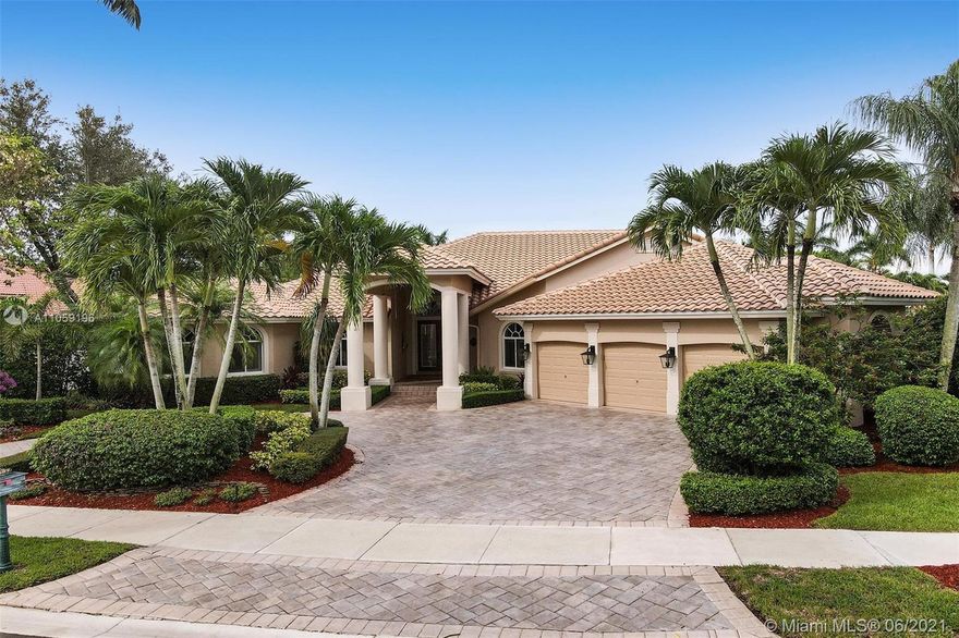 Custom-built sprawling ranch built by Foglia-Dupree tucked on a royal palm tree-lined street in the boutique community of Princeton at Weston Hills Country Club. Perched on a nearly one-half acre lot, lushly landscaped for privacy. New Roof in 2019. Renovated heated screened salt pool/spa, expansive paver patio w/ summer kitchen. Enjoy 4,418 square feet under air with 4 spacious bedrooms plus an office, and playroom with closet and bath. MBR sitting room, 4.5 baths, and french doors to the side of home with quaint patio and yard.Coastal decor flows throughout this magnificent home. Attention to detail with coffered tray ceilings, diagonal tile in living areas, wet bar in great room and plantation shutters throughout. Gourmet kitchen w/ wood cabinetry and granite