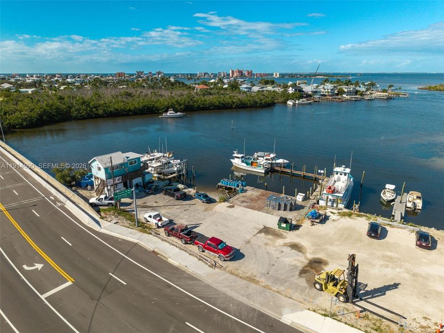 Prime Bayfront Commercial Property – Minutes from Fort Myers Beach! Located on San Carlos Blvd, just one mile from downtown Fort Myers Beach, this waterfront commercial parcel offers direct Gulf access and endless potential. Surrounded by successful marine and tourism businesses—fishing charters, boat rentals, parasailing, tiki tours—this site ensures high visibility and synergy. Within walking distance to restaurants and bars, with owned submerged land and a large dock ready for immediate use, it’s ideal for marine, hospitality, or eco-tourism ventures. Rare investment in a thriving coastal corridor.