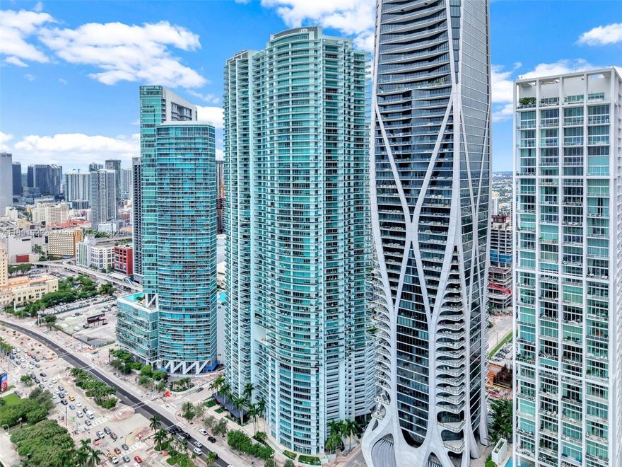 SHORT OR LONG TERM RENTAL! Soaring on the 49th floor, this corner residence offers amazing panoramic bay, city, and sunset views from almost any rooms. Massive wraparound balcony. 1,694 sq. ft. of living space with 3 bedrooms and 3.5 baths, fully and elegantly furnished and move-in ready. Private elevator entry opens to a light-filled layout with sleek finishes and stainless steel appliances. Primary suite features a spa-style bath with shower/tub combination.Dedicated laundry room and one assigned parking space add convenience. The building offer resort-style amenities: gym, sauna, steam, jacuzzi, cold plunge, pool, residents lounge, screening room, valet & 24/7 attended front desk. Price is based in a year lease, for seasonal rentals contact agent for pricing.
