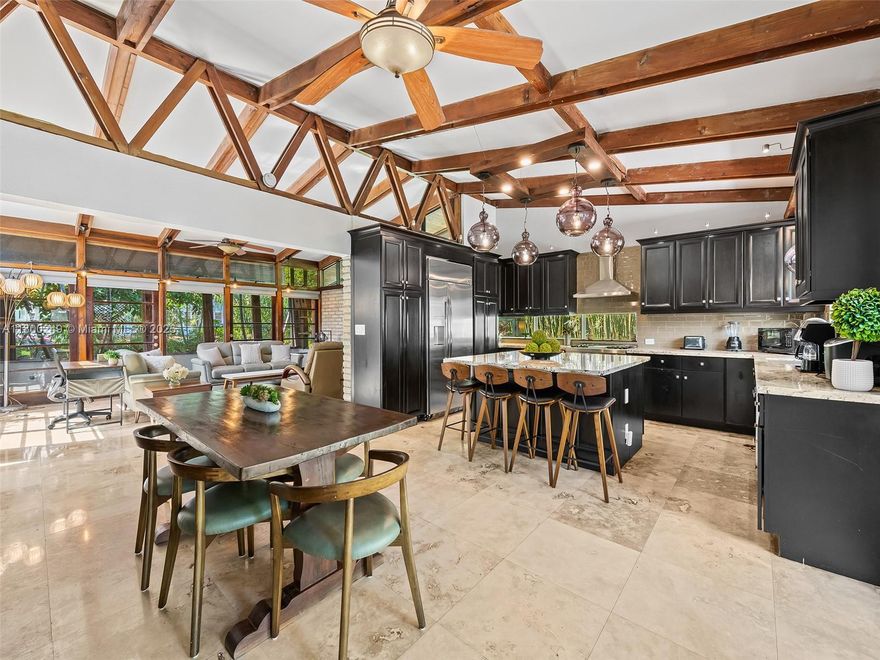 Welcome to The Porch House—a rare opportunity to own a piece of South Florida architectural history. Designed by iconic mid-century architect Igor B. Polevitzky, this 3-bed, 2-bath gem showcases his vision of tropical modernism. Featuring slump brick walls, an exposed structural-timber vaulted roof, floor-to-ceiling glass, and open-concept living, it’s filled with natural light. The gourmet kitchen offers a gas range, built-in fridge, and sleek layout ideal for entertaining or everyday living. Surrounded by lush tropical landscaping, the home offers privacy and seamless indoor-outdoor flow to a sunlit pool and lounge area. Located just blocks from downtown Hollywood and the iconic Hollywood Beach Broadwalk, this is a unique chance to own a home of pedigree, serenity, and lasting style.