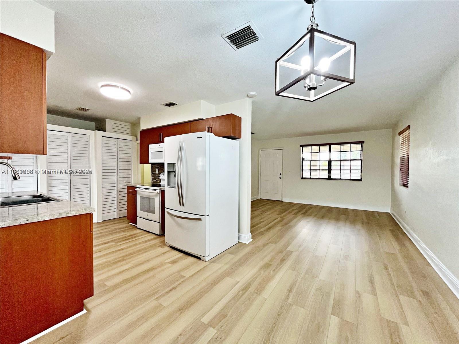 Welcome to your charming and centrally located retreat! This beautifully updated home features brand-new floors, doors, and fresh paint throughout. Bright natural light fills the open dining and living areas, while a versatile extra room is perfect for a home office, gym, or creative space. With three spacious bedrooms, two full bathrooms, and the convenience of indoor laundry, this home is designed for comfort and functionality. Outside, you’ll enjoy a large carport, an expansive yard, and plenty of room to relax or entertain.