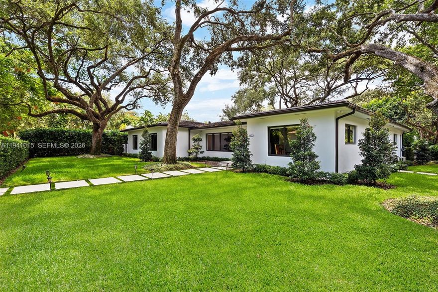Fully renovated 3 bedroom, 4 bath contemporary corner residence in the heart of Coral Gables Golden Triangle area. This home features an open floor plan with wood floors throughout, a fenced yard with heated pool and spa, surrounded by beautifully landscaped, meticulously trimmed oak trees with lighting. Additional highlights include a two-car air conditioned garage, freshly painted interior and exterior, a new laundry/storage room, Lutron lighting system, NVR hardwired security cameras with app access, and TVs included. Space to expand square footage.