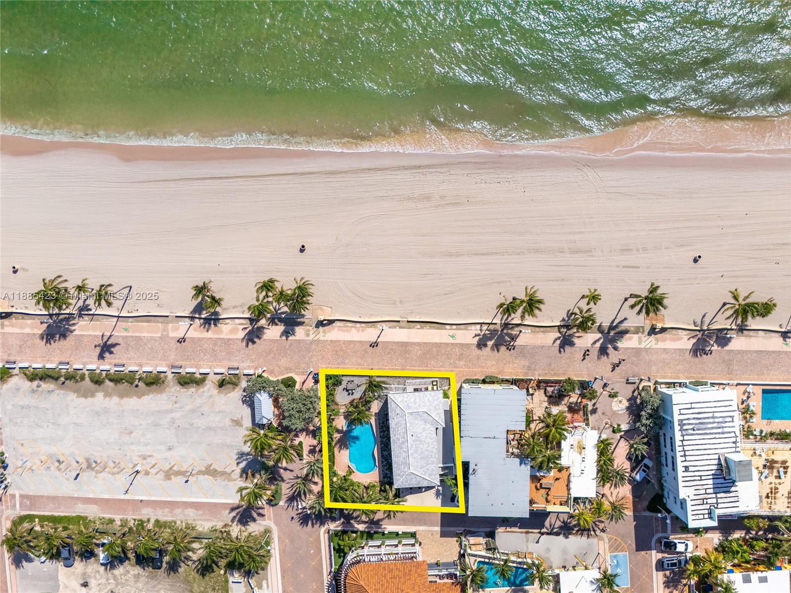 Experience South Florida living with this rare double-lot property directly on the sand and iconic Hollywood Beach Boardwalk. Offering unmatched potential, it is currently configured as a 3-bedroom, 2-bath residence on the main level and a 2-bedroom, 2-bath residence above, each with its own private kitchen and laundry. Perfect for multi-generational living or income opportunities, the home opens to a private pool oasis framed by swaying palms, just steps from the sand and surf. Ideally located near Downtown Hollywood, Fort Lauderdale–Hollywood International Airport, and I-95, this residence combines convenience, exclusivity, and beachfront lifestyle.