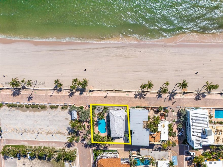 Experience South Florida living with this rare double-lot property directly on the sand and iconic Hollywood Beach Boardwalk. Offering unmatched potential, it is currently configured as a 3-bedroom, 2-bath residence on the main level and a 2-bedroom, 2-bath residence above, each with its own private kitchen and laundry. Perfect for multi-generational living or income opportunities, the home opens to a private pool oasis framed by swaying palms, just steps from the sand and surf. Ideally located near Downtown Hollywood, Fort Lauderdale–Hollywood International Airport, and I-95, this residence combines convenience, exclusivity, and beachfront lifestyle.