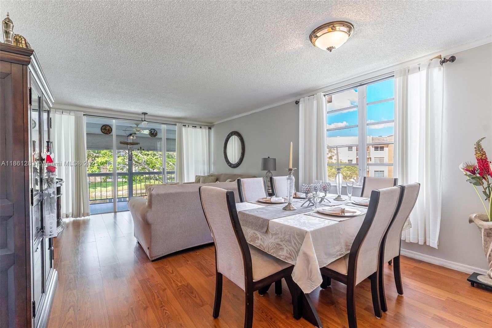 Escape to your tranquil residence! This beautifully updated 2-bed, 2-bath corner unit condo offers a serene lake view and a spacious screened-in patio, perfect for relaxing. Enjoy a bright, open floor plan with an abundance of natural light throughout. The home features gleaming wood floors and a modern kitchen with black granite countertops and stainless steel appliances. The primary bedroom boasts an ensuite bath, while the second bedroom serves as a versatile office space. Being a corner unit, you'll benefit from added privacy and a more open feel. Experience the best of Florida living!