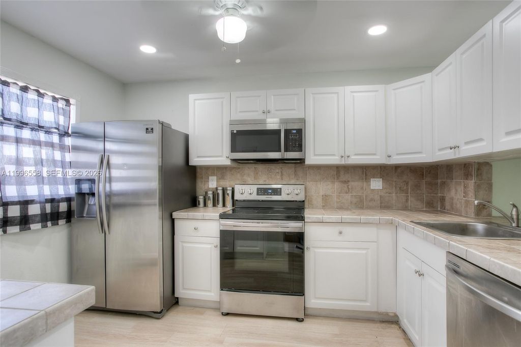 Photo of 8810 W Mcnab Rd #306, Tamarac, FL 33321 (MLS # A11996558)