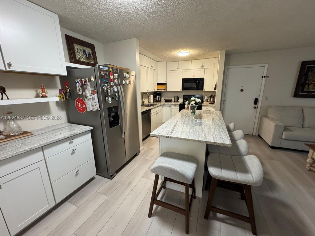 Photo of 10425 E Clairmont Cir #107, Tamarac, FL 33321 (MLS # A12024887)