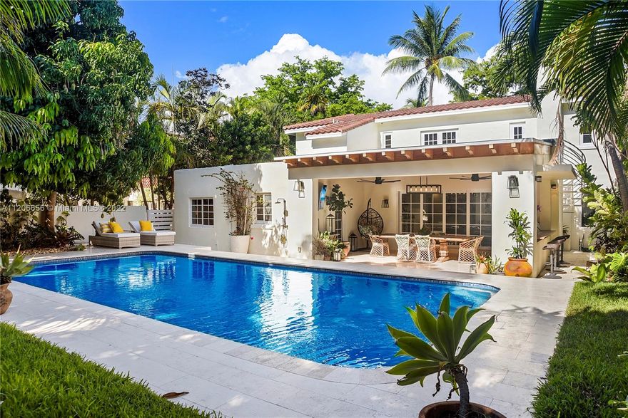 Renovated & ready for you! Completely gated, private oasis on prestigious Pine Tree Drive! No expense was spared while remodeling this home, featuring a new open gas kitchen w/ Wolf & Sub Zero appliances, & island, new impact windows & doors, carport w/ garage door, & new A/C, & electrical! Fantastic layout w/ 1 BD down w/ access to private backyard, & 3 BD upstairs w/ custom closets, including primary suite w/ terrace. Also offering stunning porcelain tile & wood floors, impressive great room w/ fireplace, wine storage, & Florida room w/ sliding doors that completely recess. Step outside & fall in love w/ your new terrace w/ covered summer kitchen w/ ice maker, TV, & Sonos system, recently redone PebbleTec heated saltwater pool, shower, lush landscaping, & gorgeous mango trees!