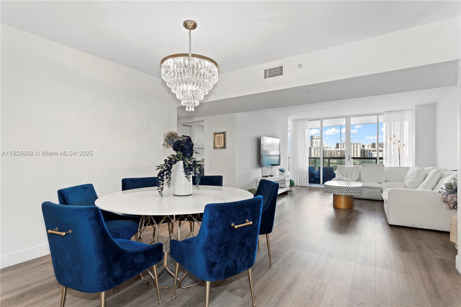 Experience modern living in the heart of Aventura with this spacious 3-bedroom, 2-bathroom residence offering 1,700 square feet of beautifully designed open-concept living. The unit features sleek flooring, a neutral color palette, and an abundance of natural light, creating a warm and inviting atmosphere ideal for both relaxing and entertaining. The seamless flow between the living and dining areas is complemented by sophisticated finishes, including a statement chandelier and stylish, contemporary furnishings. Residents enjoy resort-style amenities such as a state-of-the-art fitness center, multiple swimming pools, a luxurious spa, and more. This home offers the perfect blend of comfort, convenience, and the vibrant South Florida lifestyle.