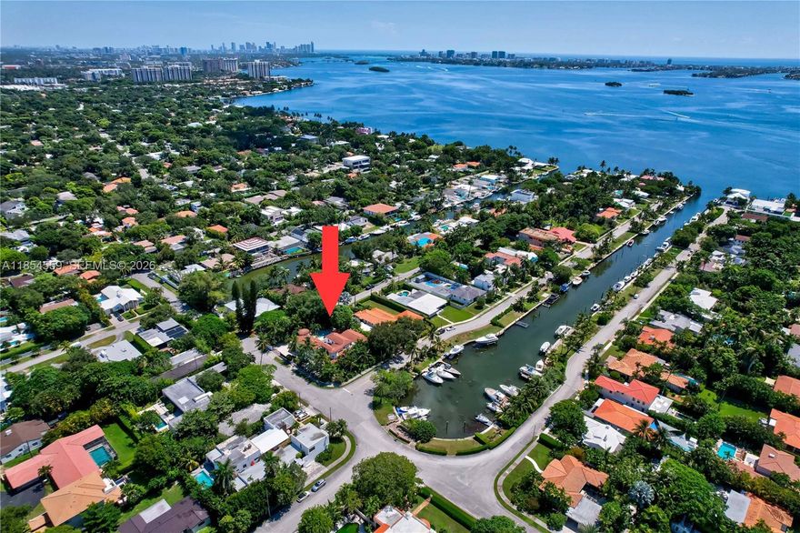 Waterfront powerhouse: 6,200+ sq ft of living space on a massive 17,000+ sq ft corner lot with 70 ft of canal frontage, private dock, and zero bridges to open ocean—true boaters’ dream. Wrapped in mature tropical landscaping with a resort-style pool built for entertaining. This 7-bedroom, 5 full + 2 half bath estate delivers scale, privacy, and serious wow factor. The primary retreat is a private sanctuary with office, dual walk-in closets, two spa-like baths, and direct access to the pool and canal. Grand entry stuns with terrazzo floors, fireplace, and dramatic staircase. Huge rooms throughout. Four bedrooms downstairs, three upstairs plus a private theater. Explore the 3D tour and drone footage to experience the lifestyle.