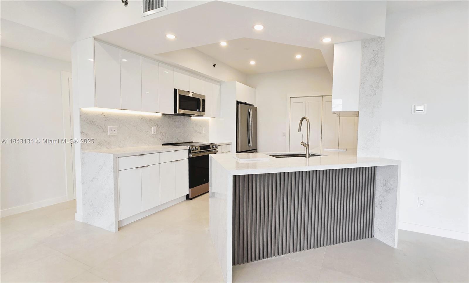 Indulge in unmatched waterfront luxury in this brand-new, fully remodeled 3-bed, 2-bath condo at Village by the Bay. This pristine residence features oversized porcelain tile floors, a sleek white kitchen with waterfall marble countertops, LED-lit dropped ceiling, and premium stainless steel appliances. Enjoy spa-inspired bathrooms and breathtaking water and canal views from your private balcony. Set in a secure gated community offering resort-style amenities: waterfront pool, modern gym, elegant clubhouse, tennis courts, BBQ area, and direct access to a scenic park. Minutes from Aventura Mall, fine dining, entertainment, and Sunny Isles Beach. Be the first to call this designer condo home, dont miss it!