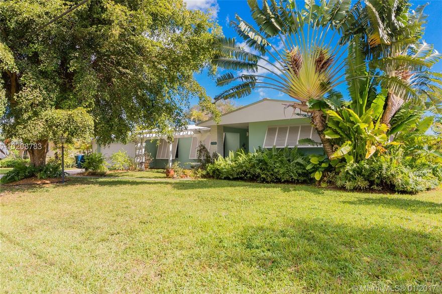 Waterfront Merion Park residence w/seawall & canal access. Updated baths & kitchen featuring wood cabinetry, granite counters & Kitchen Aid appliances, French doors, neutral tile flooring throughout. Raised-rib metal roof. Screened patio & pool w/tumbled marble patio surface, wide overhang & orchid house. 2 car garage & separate storage shed. Quiet low-traffic street, close-in, convenient location just minutes to South Miami shopping & restaurants.