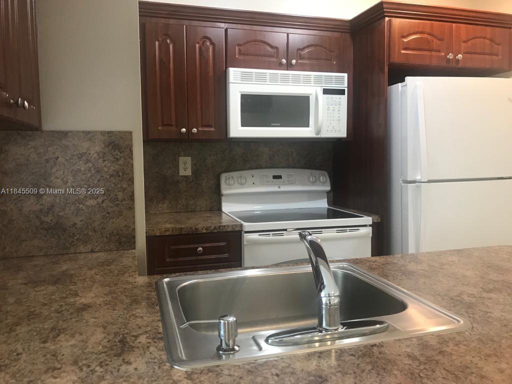 Updated and cozy in the heart of Miami Lakes. Very nice unit in sought after Antigua. It features updated kitchen cabinetry, update bathroom, all tiled flooring, washer and dryer inside unit. Only one vehicle per unit allowed. No space for second vehicle.