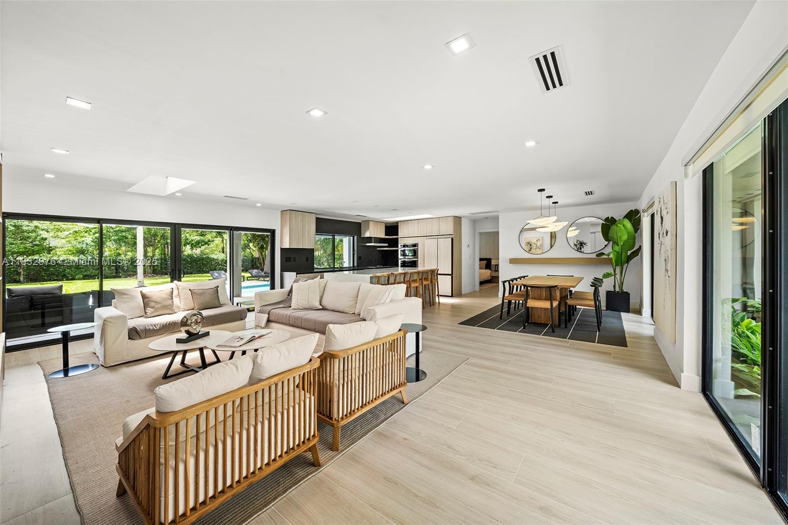 Meticulously redesigned with luxury finishes and impeccable taste—this home is move-in ready and has never been lived in. Located on a unique oversized 21,875 sq ft corner lot, surrounded by lush landscaping and majestic trees that provide exceptional privacy. Features 5 bedrooms, 3.5 bathrooms, and 2,438 sq ft under A/C (per builder). Open living, dining, and kitchen showcasing custom elements not commonly found on the market: natural stone, wood accents, and stainless steel appliances. The primary suite includes a built-in bookshelf, custom walk-in closet, and spa-like bath. Second suite with cabana bath. Expansive 55-ft covered terrace creates an elegant outdoor living and dining area. Impact windows, new metal roof, 1-car garage with laundry. A rare market gem.