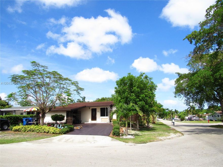 Corner house with a beautiful landscaping, circular driveway, tile through out, open concept kitchen with granite counters, and stainless steel appliance,  impact windows, newer mini split unit, central air,  remodeled bathrooms., spacious closets in main bedroom, and so much more.