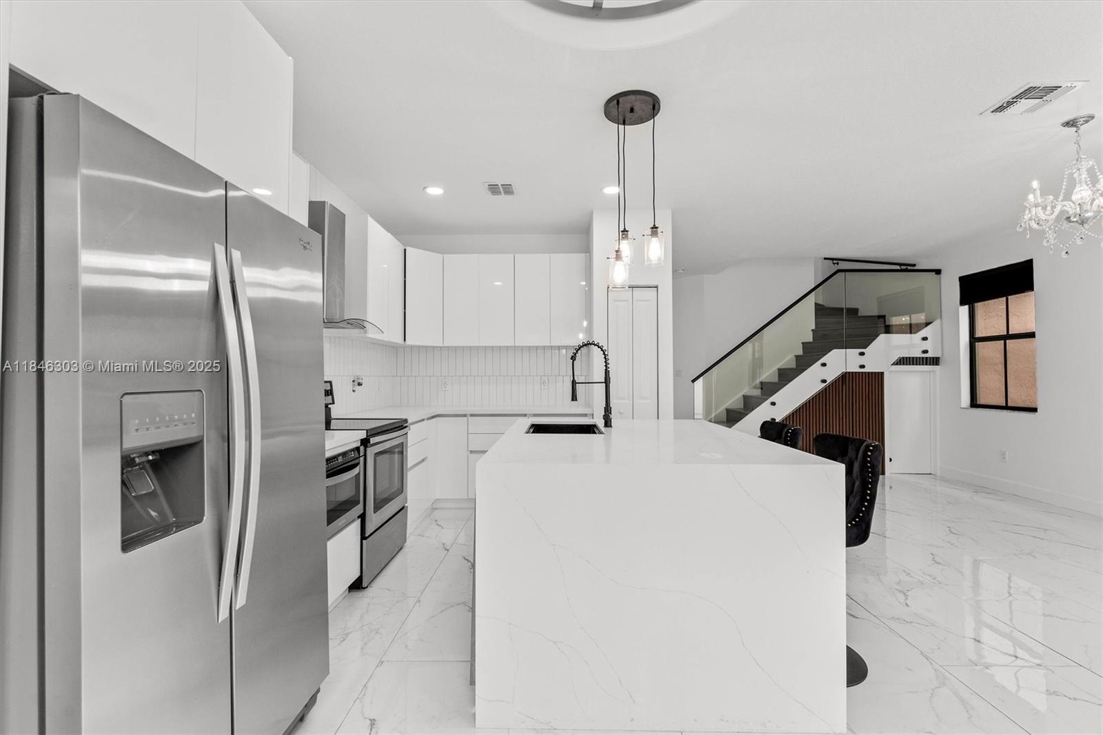 Step into luxury with this stunningly remodeled 3-bedroom, 2.5-bathroom home where modern style meets everyday comfort. From the moment you enter, you’ll be impressed by the sleek new marble flooring flowing throughout, creating a seamless and elegant feel. The show-stopping kitchen is a true centerpiece, featuring designer cabinetry, striking quartz countertops, and high-end stainless steel appliances—perfect for cooking and entertaining. A statement glass staircase adds a touch of modern sophistication and floods the space with natural light. Upstairs, the spacious primary suite feels like a private spa retreat, with a custom-tiled walk-in shower, deep soaking tub, and beautifully crafted built-in closet system. Enjoy the community pool and play ground!
