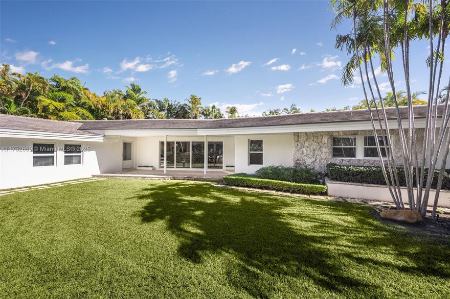 An exquisitely remodeled residence on an expansive 11,524 sq. ft. lot along prestigious Harbor Drive, just steps from the Key Biscayne Yacht Club. This high-elevation (8.1 ft) home offers a thoughtfully designed 4-bedroom, 3-bathroom split floor plan with Jerusalem stone flooring throughout. The spacious kitchen features granite countertops, custom wood cabinetry, and seamless flow into the family and dining areas, highlighted by soaring 12-foot ceilings. Expansive windows invite natural light. The primary suite is a serene retreat with ample closet space and a spa-like bath. With 2,960 sq. ft. of living space, the property also includes potential for a maid’s quarters with a private entrance, offering flexibility and convenience. A rare opportunity in Key Biscayne’s desirable location.