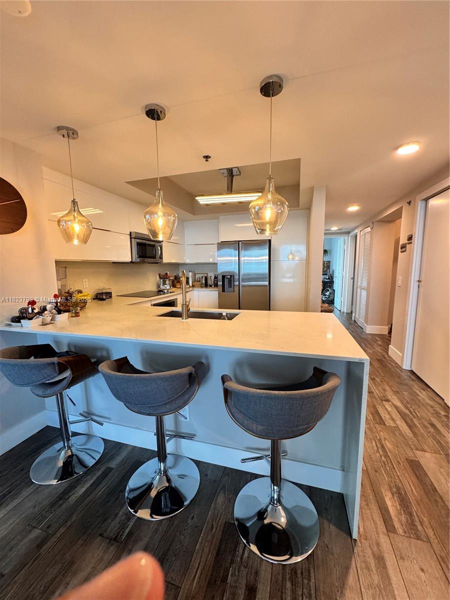 Fully remodeled 3 bed, 3 bath residence in the upscale Tao at Sawgrass. This 1,546 sq ft 9th-floor unit offers stunning lake and skyline views, spectacular sunsets, floor-to-ceiling windows, and two private balconies. Featuring brand-new wood-look floors, ambient LED lighting, and a designer kitchen with quartz waterfall countertops, high-gloss cabinetry, and stainless steel appliances. Two bedrooms include in-suite baths, while the third full bath serves the third bedroom and guests. The spacious layout is perfect for both relaxing and entertaining. Enjoy resort-style amenities: tropical pool, full gym, sauna, tennis courts, conference room, and 24/7 concierge and security. Prime location just steps from Sawgrass Mills Mall, fine dining, and major highways.