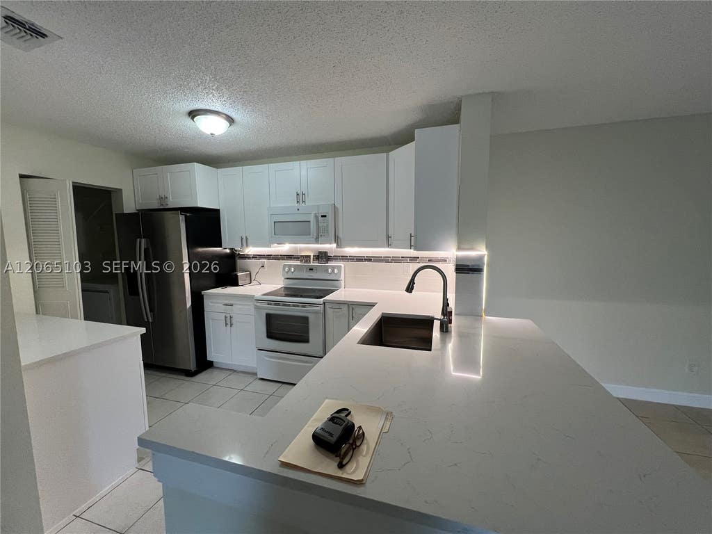 Photo of 11277 W Atlantic Blvd #304, Coral Springs, FL 33071 (MLS # A12065103)