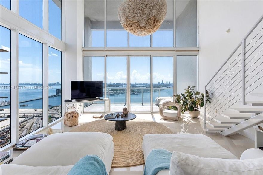Spectacular corner loft-style residence with soaring 20-foot ceilings and walls of glass framing panoramic east-facing views of turquoise Biscayne Bay, Museum Park, & the ocean beyond. Soaked with natural light, this spacious 2-bed/2.5-bath offers a front-row seat to watch cruise ships set sail while enjoying the ultimate Miami backdrop. Modern and sleek, the open design blends style and comfort seamlessly. Ten Museum Park delivers boutique ultra-luxury living with resort-style amenities: multiple pools, cold plunge, spa with steam/sauna, fitness/yoga areas, sky garden, & exclusive Bentley Beach Club access. Live across from Museum Park, the bay, PAMM Art & Frost Science Museums, and steps to Arsht Center, Kaseya Center, the new Miami Worldcenter, & the future 33-acre Signature Bridge park