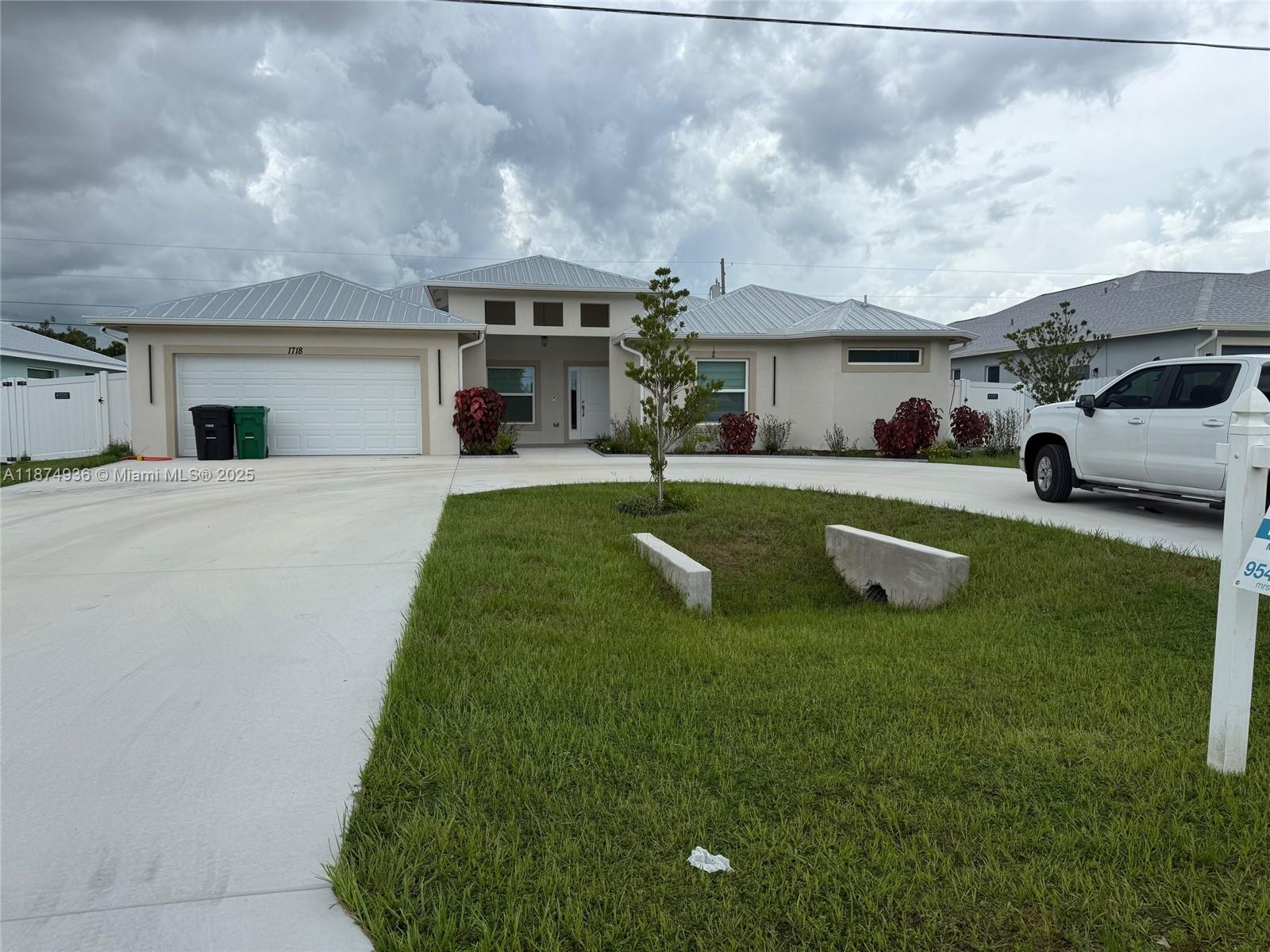 2025 Spacious 5-bedroom, 3-bath home with office and den/family room. with a 5V metal roof, impact windows/doors, and fenced yard. The kitchen and laundry feature 42'' high cabinets, quartz countertops, and a glass backsplash. Porcelain tile enhances main areas; Crown molding, baseboards, and a luxurious primary suite with walk-in closets, designer shower, and free-standing tub . Includes new kitchen stainless steel appliances. Supersized circular driveway, covered patio, and gutters. Move-in ready!