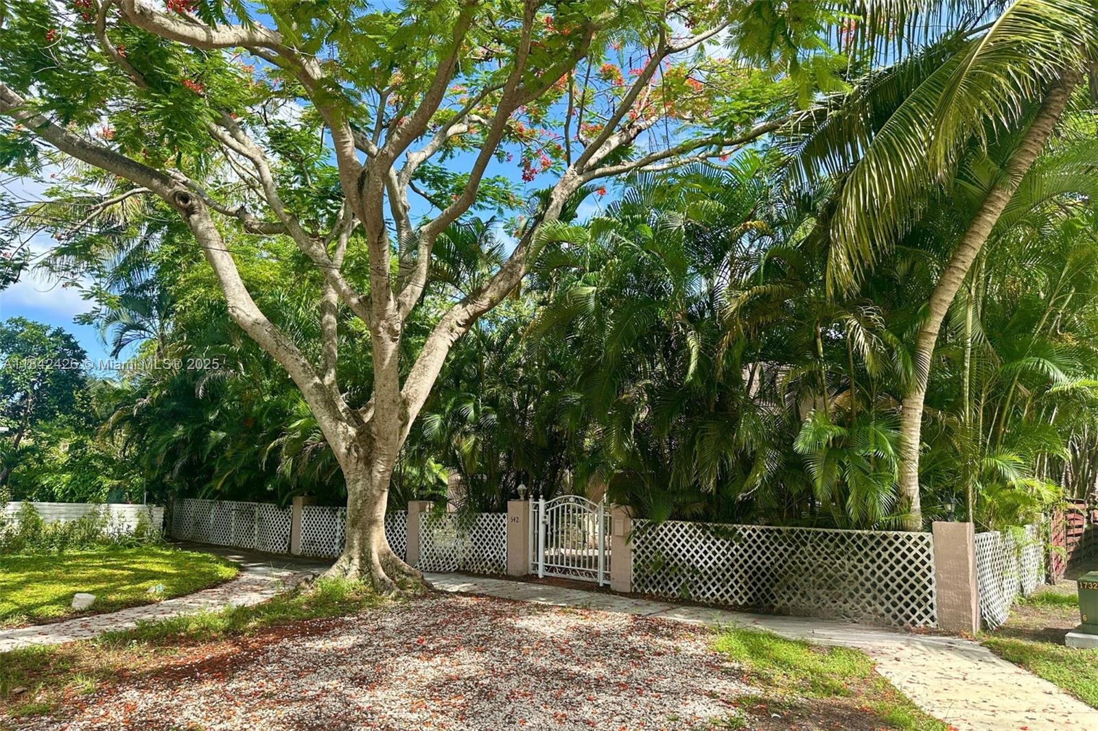 Available Now – Charming 1920s Home in North Miami. Situated on a quiet street overlooking a peaceful parkway, this 3-bedroom, 2-bathroom home offers timeless character just steps from the lively 125th Street corridor. The layout includes a Florida room, double living area, kitchen with garden access, and a spacious master suite added in 2014, complete with a large walk-in closet and private bathroom. Original details such as an historic fireplace, terracotta tile and stained concrete floors, and designer ceiling fans add unique vintage charm. The large fenced backyard features mature landscaping, exterior lighting, and a private garden, ideal for relaxing or entertaining. Ample storage, high speed fiber internet. Rare find in a quiet, friendly neighborhood.