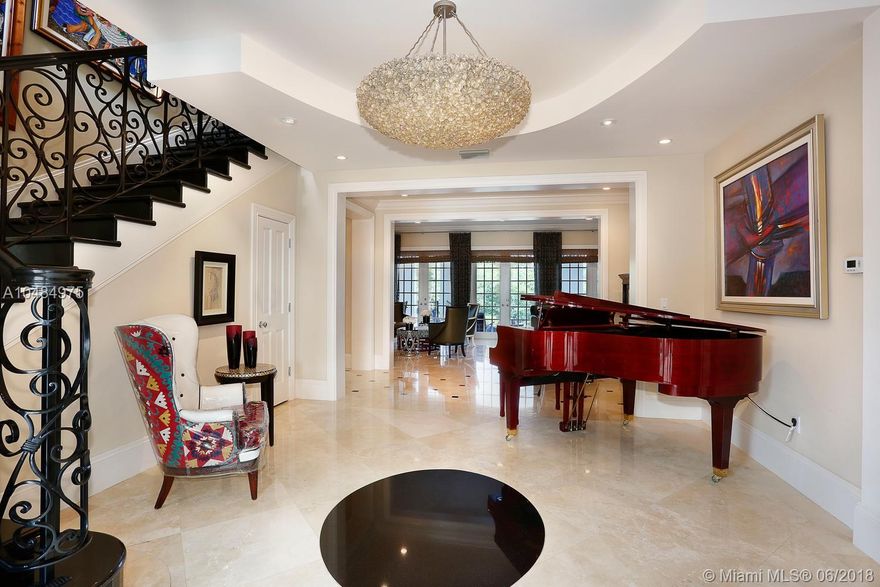 Elegant and imposing transitional style waterfront estate with private dock across from natural preserve. Updated and exquisite. Marble and wood flooring. Meticulously crafted millwork. Gracious formal living with fireplace and wet-bar. formal dining rooms. Gourmet chef's kitchen open to fabulous and large family room. Second floor master suite with sitting area, additional office. All with pretty and open vistas. Front and back staircases. Maid's quarter. Impact windows and french doors throughout. Large covered patio with built-in grill. Cabana bath. Great for entertaining and family comforts. Light and bright! Situated on pretty cul-de-sac street. Walk to tennis court! A beautiful home and fabulous offering!  Appts with notice please.