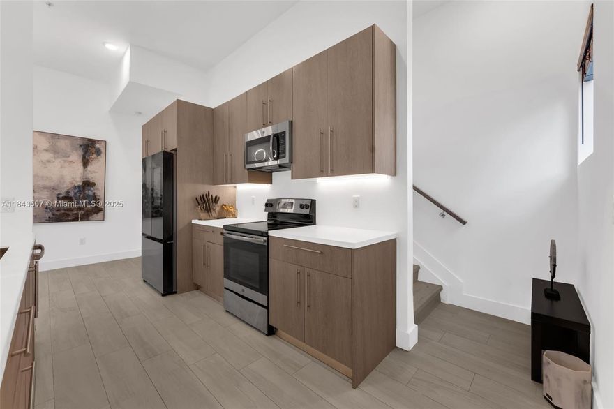 Sleek, stylish, and sun-drenched—this corner townhome in Plantation delivers 1,672 sq ft under air and nearly 2,000 sq ft including a 2-car garage. Built in 2018 with modern flair, it features soaring ceilings, designer finishes, and a show-stopping kitchen with quartz counters and black stainless appliances. Upstairs, the primary suite stuns with dual walk-ins, a spa-inspired bath, and private balcony. Loft/office adds flexibility. Prime location near top schools, parks, and everything you need. This is the lifestyle upgrade you’ve been waiting for.