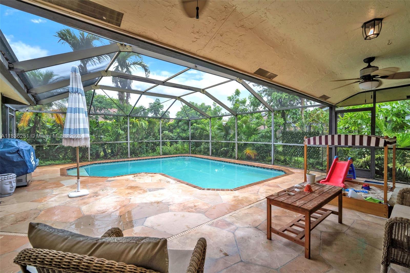 Charming 3-bed, 2-bath single-story home with split bedroom layout, 2-car garage, and spacious screened-in pool with partially covered patio, perfect for Florida living. Enjoy an updated kitchen with granite counters, island, stainless-steel appliances, and soft closed cabinets-drawers. Laminate wood floors flow through all living areas, while abundant windows fill the home with natural light. Features include indoor utility room with Bosch washer/dryer, a new sprinkler pump and automatic garage door opener. Located near Coral Springs High, parks, shopping, dining, grocery stores and less than a mile from a fire station.