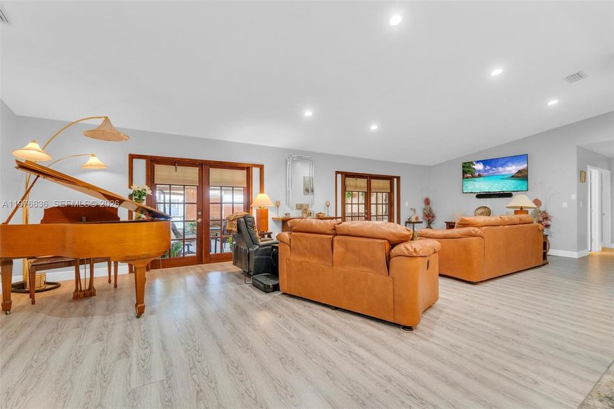 Sanctuary in the heart of Palmetto Bay! This spacious 5-bedroom residence perfectly blends elegance, comfort, and modern living. Step inside to discover lavish open spaces adorned with new laminate flooring that flows effortlessly throughout the home, creating a seamless blend of style and warmth. The open-concept kitchen invites both gourmet cooking and everyday gatherings, while the expansive covered and screened patio sets the stage for unforgettable evenings of entertaining or peaceful relaxation. Designed for today’s lifestyle, this home features a dedicated indoor fitness area, serenity room for reflection, a private in-law suite, and a flex office space!  Offering the perfect combination of functionality and retreat. Don't miss your chance to own a piece of paradise in Palmetto Bay