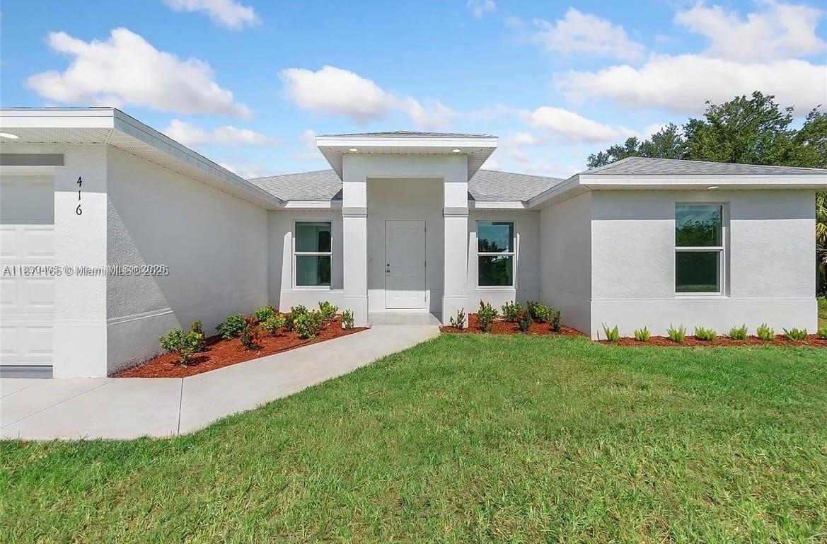 This newly constructed home offers the perfect blend of modern design and comfortable living. The spacious, open floor plan is ideal for entertaining and features a seamless flow from the living area to the dining and kitchen spaces. As a true energy-efficient home, it features impact windows and doors and is fully tiled throughout for easy maintenance. The private master bedroom suite is a true retreat, boasting a generously sized master bathroom with dual closets. The home also includes a one-car garage with an integrated laundry area for added convenience. Enjoy outdoor living and privacy in the huge backyard, perfect for recreation or relaxation.