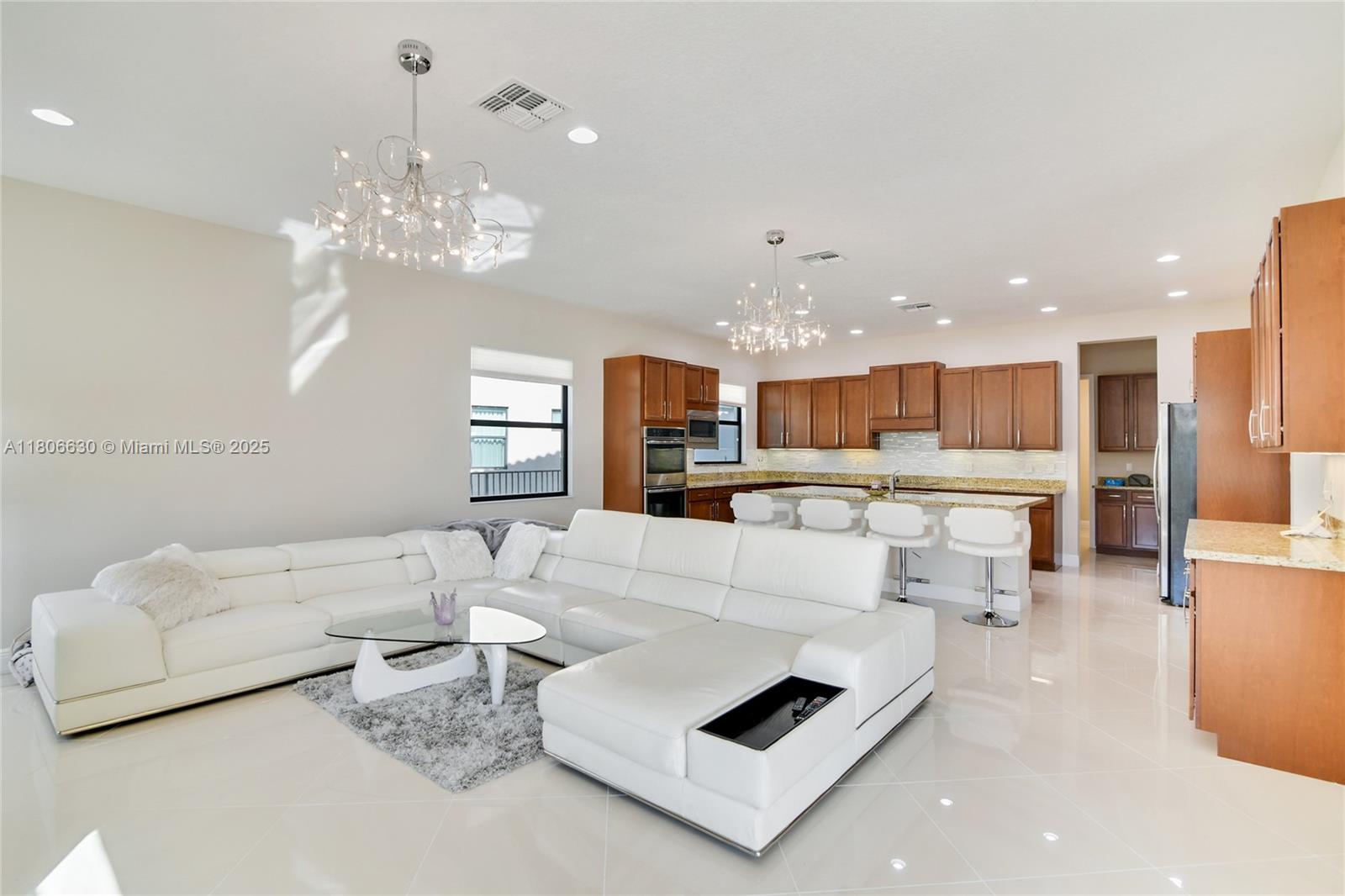 Welcome to Paradise! ANNUAL, FURNISHED, Stunning home with pool in Boca Reserve offered for lease. This home was built for entertaining offering immaculate gourmet kitchen, 5beds/4.5baths plus large den. Custom built pool 8ft deep with sunbed, waterfalls, slide & shaded table area. Master suite includes enormous his and her closets, luxury master bath, separate tub & shower over-sized bedroom & balcony overlooking lush, private, lakefront back yard. Newer construction. Located conveniently by world class shopping and restaurants, parks and recreational facilities, with A-rated schools. Porcelain tile throughout living areas and new carpet in bedrooms. Separate laundry room & 3 car garage. Gated and private community, rarely available. NO SHORT TERM RENTALS ALLOWED