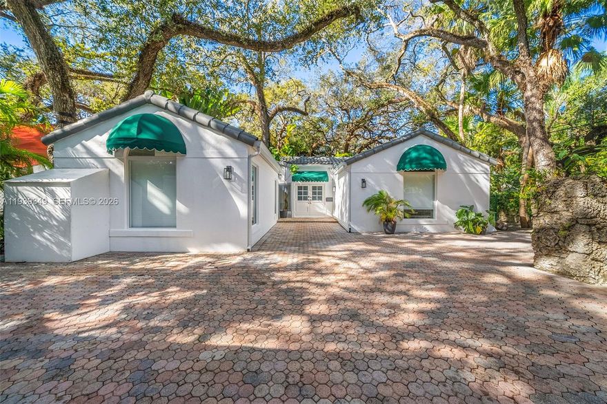 Nestled in the desirable South Coconut Grove neighborhood, this 4-bedroom, 2.5-bathroom home feels like a private tropical retreat, surrounded by spectacular mature foliage and oak trees. Beautifully renovated and move-in ready, this one-story corner-lot residence features a modern kitchen and bathrooms, all impact-glass windows and sliding doors, and a dramatic wall of windows that fills the home with natural light while offering serene views of the garden and pool from nearly every room. The fourth bedroom is currently configured as a family/media room but can easily be converted back to a bedroom. Enjoy spacious gated parking behind an electric gate and the convenience of walking or biking throughout the Village of the Grove. Ideally located near Miami’s best urban neighborhoods, this home offers the perfect blend of privacy, charm, and accessibility.