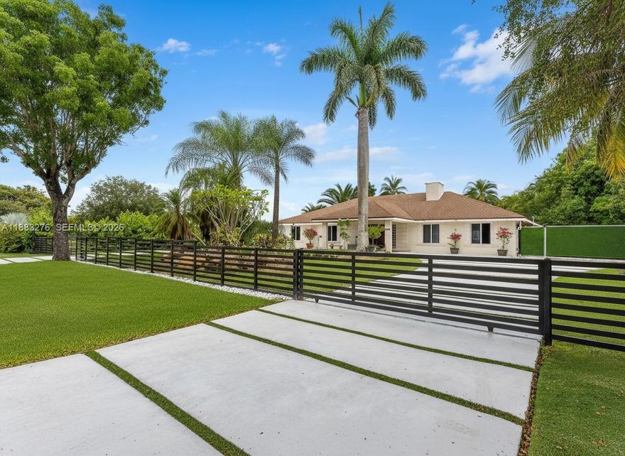 5467 SQ FT HOME.  Main house is 3923 SQ FT Guest house is 1544 SQ FT Welcome to your luxurious oasis! Has an office. a functional gym and a Dedicated theater room.  Stunning property on a private road, offers you the epitome of luxury, exclusivity, and privacy on a builder’s acre. Fully remodeled in 2024/2025.  5 bedrooms, 3.5 baths and new addition. Main house is a 3/2.5.  Guest house is a 2/1 with a huge great room and full kitchen. Large gym in the main house could be converted to another bedroom.  Open kitchen design with island & quartz counters, SS appliances, impact windows, vaulted ceilings, fireplace, security cameras, putting green/playground, Heated Endless Pool with slide, 2 gazebos, electric aluminum fence, gym, home theater, commercial water purification, lush landscaping featuring 175-ft Royal Palms, 33,500 ft concrete driveway, carport, basketball court, double roof design with skylights 2016/2024. Huge luxurious 700sf master suite with 2025 master bath and family room. Original owner